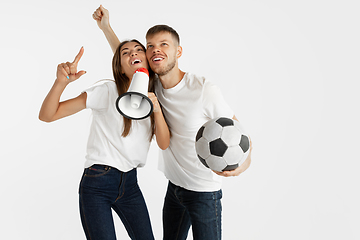Image showing Portrait of beautiful couple football fans on white studio background
