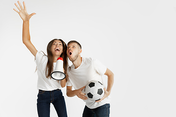 Image showing Portrait of beautiful couple football fans on white studio background