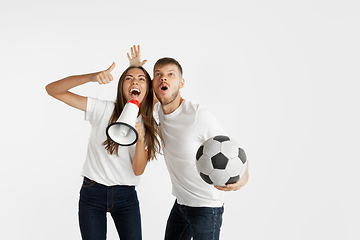 Image showing Portrait of beautiful couple football fans on white studio background