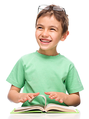 Image showing Little boy is reading a book