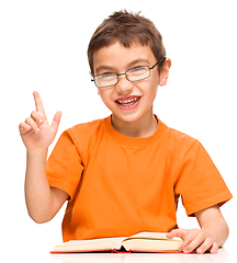 Image showing Little boy is reading a book