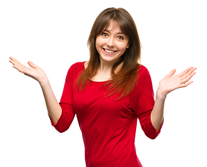 Image showing Portrait of a young woman raised her hands up