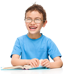 Image showing Little boy is reading a book