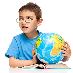 Image showing Little boy is holding globe