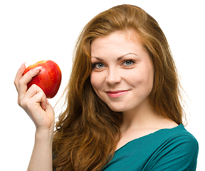 Image showing Young happy girl with apple