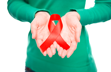 Image showing Woman is holding the red awareness ribbon