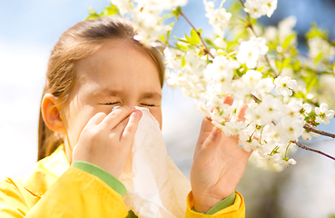 Image showing Little girl is blowing her nose