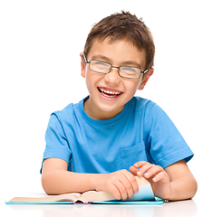 Image showing Little boy is reading a book