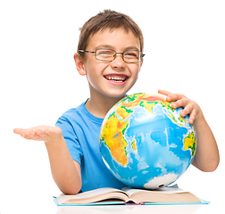 Image showing Little boy is holding globe