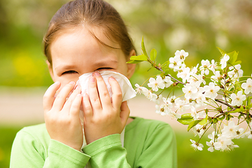 Image showing Little girl is blowing her nose