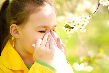 Image showing Little girl is blowing her nose