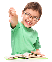 Image showing Little boy is reading a book