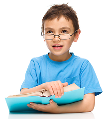 Image showing Little boy is reading a book