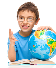 Image showing Little boy is holding globe