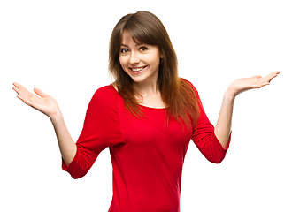 Image showing Portrait of a young woman raised her hands up