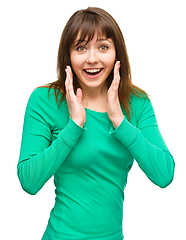 Image showing Woman is holding her face in astonishment