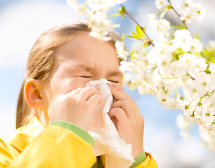 Image showing Little girl is blowing her nose