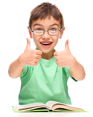 Image showing Little boy is reading a book