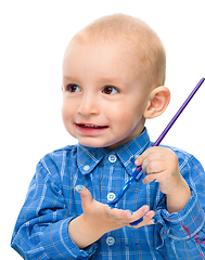 Image showing Little boy is playing with paints