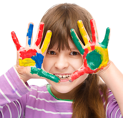 Image showing Portrait of a cute girl playing with paints