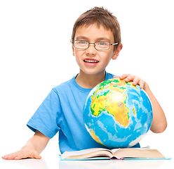 Image showing Little boy is holding globe