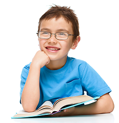 Image showing Little boy is reading a book