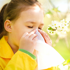 Image showing Little girl is blowing her nose