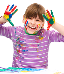 Image showing Portrait of a cute girl playing with paints