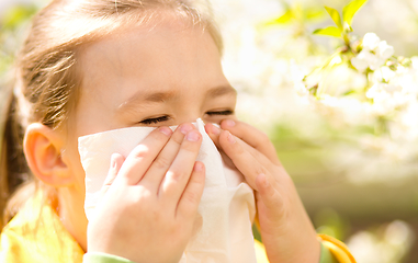 Image showing Little girl is blowing her nose