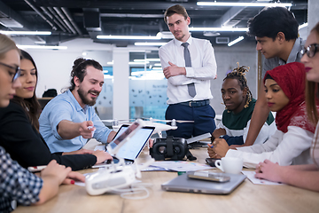 Image showing multiethnic business team learning about drone technology