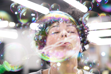 Image showing software developer having fun while making soap bubble