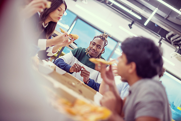 Image showing multiethnic business team eating pizza