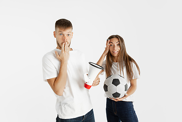 Image showing Portrait of beautiful couple football fans on white studio background