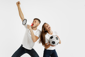 Image showing Portrait of beautiful couple football fans on white studio background