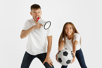 Image showing Portrait of beautiful couple football fans on white studio background