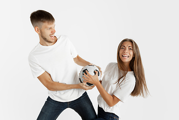 Image showing Portrait of beautiful couple football fans on white studio background