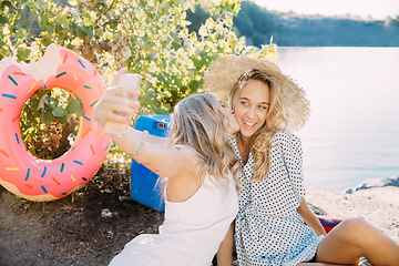 Image showing Young lesbian\'s couple having fun and spending time at riverside in sunny day