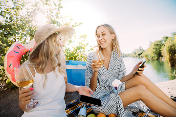 Image showing Young lesbian\'s couple having fun and spending time at riverside in sunny day