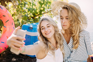 Image showing Young lesbian\'s couple having fun and spending time at riverside in sunny day