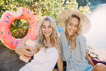 Image showing Young lesbian\'s couple having fun and spending time at riverside in sunny day