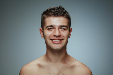 Image showing Portrait of shirtless young man isolated on grey studio background