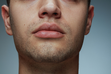 Image showing Close-up portrait of young man isolated on grey studio background