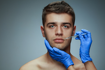 Image showing Close-up portrait of young man isolated on grey studio background