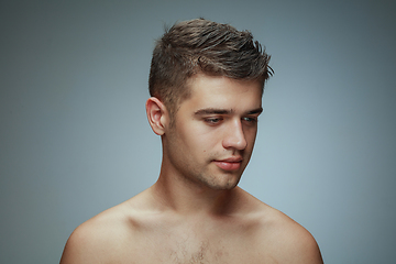 Image showing Portrait of shirtless young man isolated on grey studio background