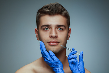 Image showing Close-up portrait of young man isolated on grey studio background