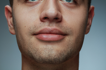 Image showing Close-up portrait of young man isolated on grey studio background