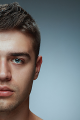 Image showing Close-up portrait of young man isolated on grey studio background