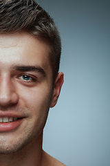 Image showing Close-up portrait of young man isolated on grey studio background