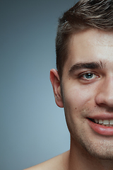 Image showing Close-up portrait of young man isolated on grey studio background