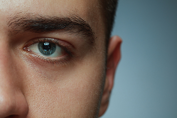 Image showing Close-up portrait of young man isolated on grey studio background